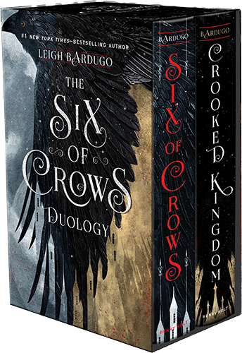 A boxed set of two books, "six of crows" and "crooked kingdom," with covers featuring stylized black feathered wings and cityscapes with architectural and fantastical elements.