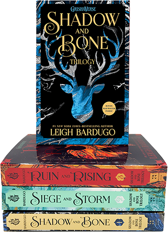 Stack of three fantasy novel books from the "Grishaverse Shadow and Bone trilogy" by Leigh Bardugo, with "Shadow and Bone" on top, displaying a dark cover with a blue, ant